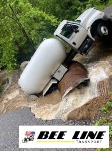 Towing company overcomes caved-in and flooded roads to rescue propane truck in Blue Ridge VA